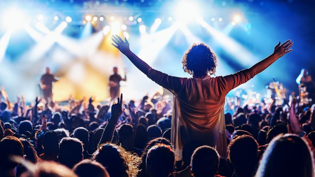 Man Standing Up In The Crowd At A Concert