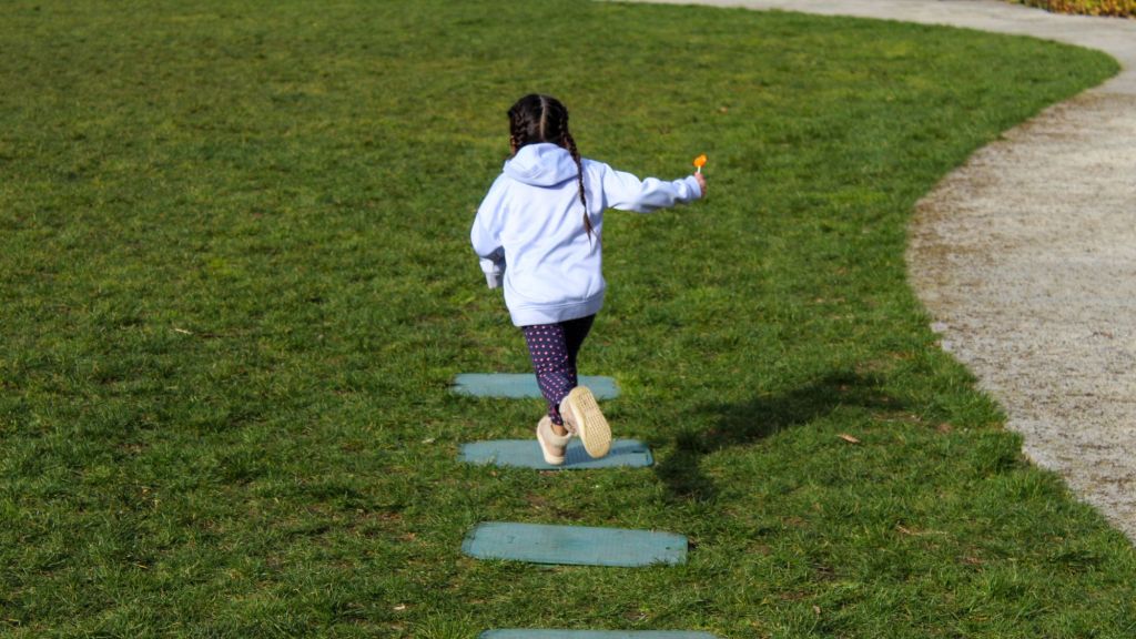 Little Girl Running Through The Park