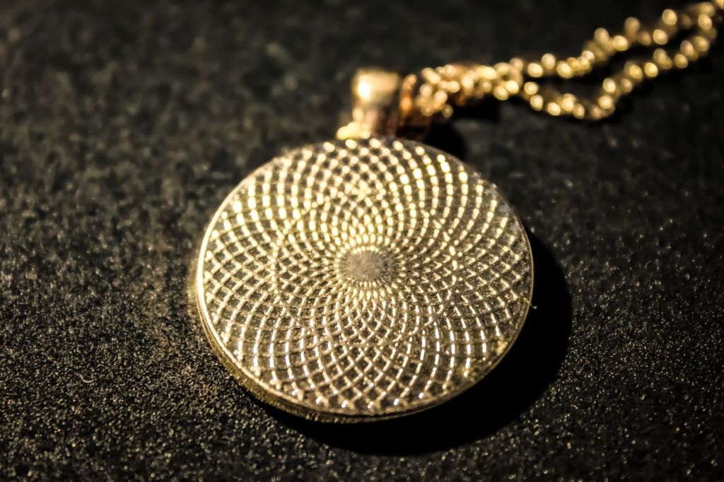 Gold Medallion With Gold Flakes And Black Background