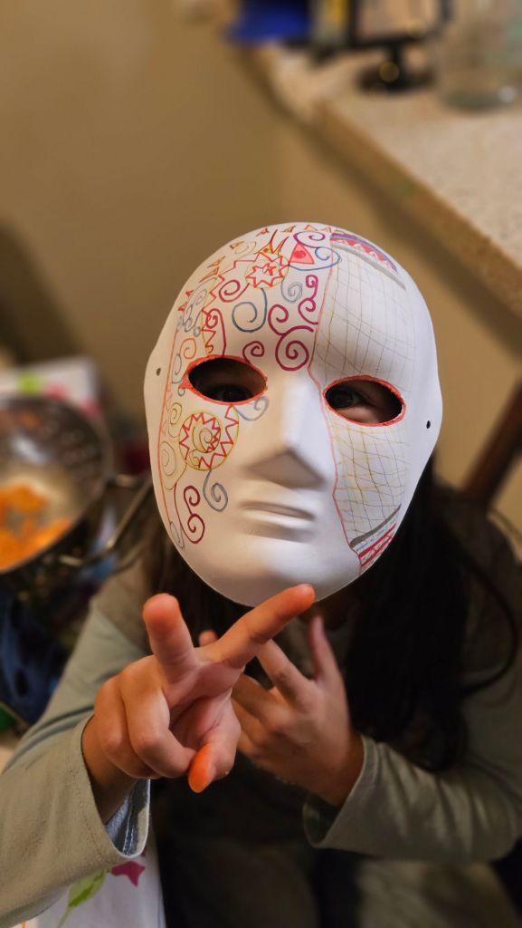 Little Girl Wearing A Costume Mask